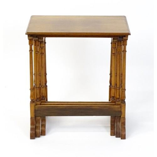 1741 - A nest of three early 20thC walnut tables each with a rectangular top, four turned pillar supports a... 