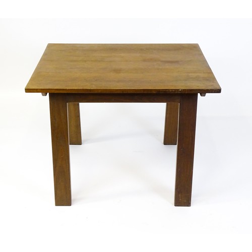 1743 - An Arts & Crafts Cotswold school oak centre table with a rectangular top above four splayed tapering... 