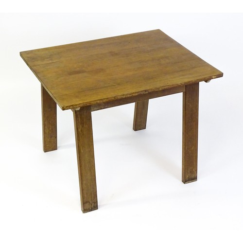 1743 - An Arts & Crafts Cotswold school oak centre table with a rectangular top above four splayed tapering... 