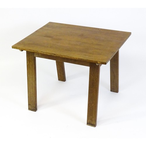 1743 - An Arts & Crafts Cotswold school oak centre table with a rectangular top above four splayed tapering... 