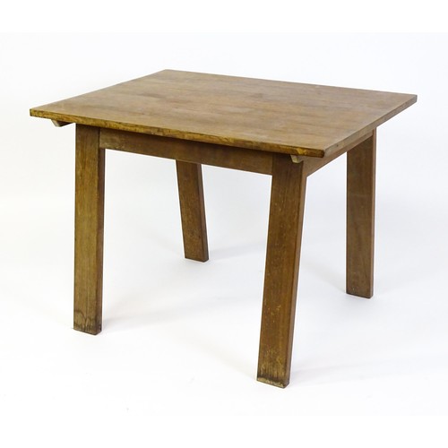 1743 - An Arts & Crafts Cotswold school oak centre table with a rectangular top above four splayed tapering... 