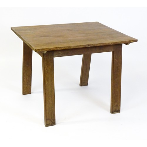 1743 - An Arts & Crafts Cotswold school oak centre table with a rectangular top above four splayed tapering... 