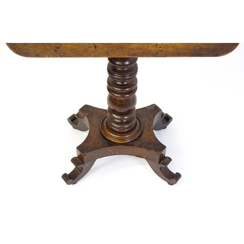 1744 - A mid 19thC mahogany occasional table with a rectangular tilt top above a turned pedestal and quad f... 