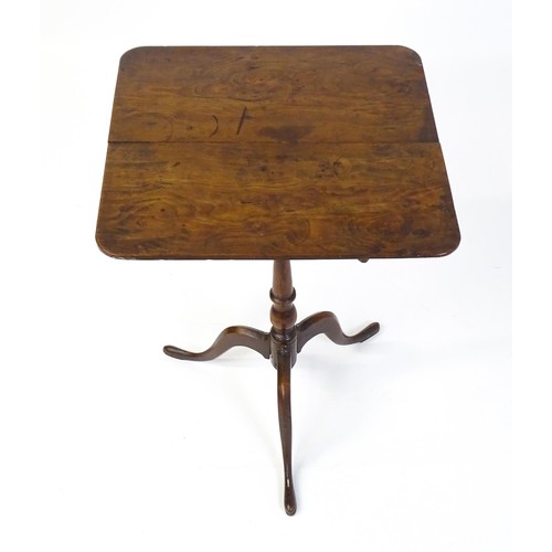 1750 - A late Georgian tripod table with a squared yew wood table top above a turned tapering mahogany pede... 