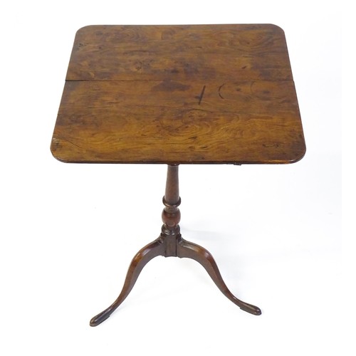 1750 - A late Georgian tripod table with a squared yew wood table top above a turned tapering mahogany pede... 