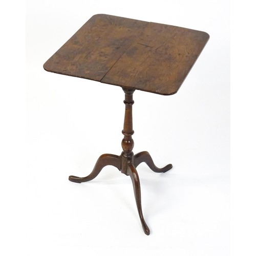 1750 - A late Georgian tripod table with a squared yew wood table top above a turned tapering mahogany pede... 