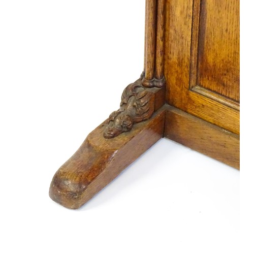 1752 - A 19thC oak Davenport with a leather inset writing slope above a panelled front and sides with Gothi... 