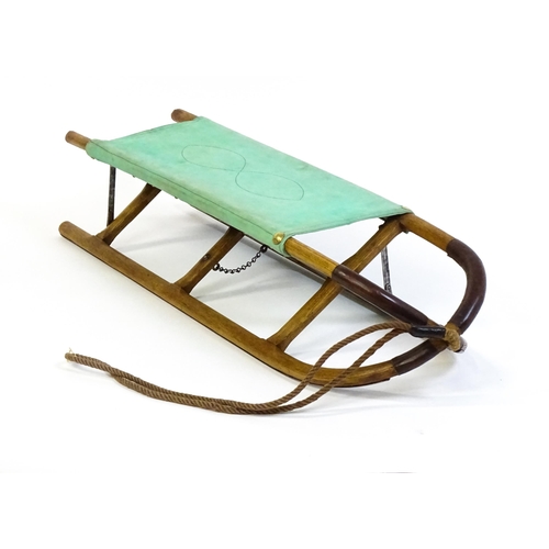 1261 - A 20thC small folding stretcher / sledge with an x-frame. Approx. 52