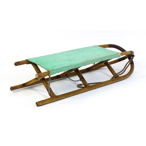 1261 - A 20thC small folding stretcher / sledge with an x-frame. Approx. 52