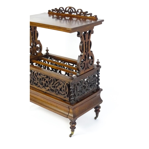 1527 - An early / mid 19thC rosewood Canterbury with a rectangular figured top above lyre shaped supports a... 