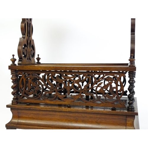 1527 - An early / mid 19thC rosewood Canterbury with a rectangular figured top above lyre shaped supports a... 