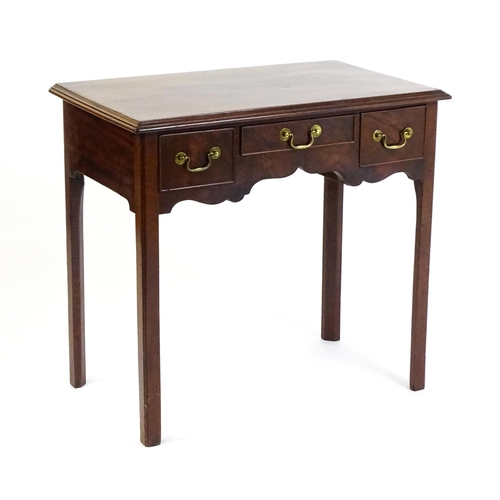 1528 - A Georgian mahogany lowboy with a moulded top above three short drawers and raised on four chamfered... 