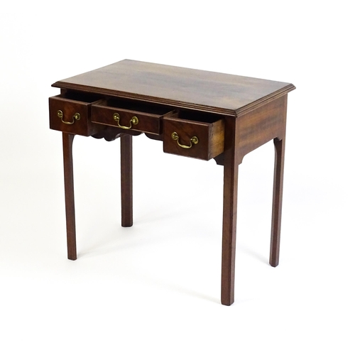 1528 - A Georgian mahogany lowboy with a moulded top above three short drawers and raised on four chamfered... 