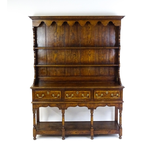 1532 - A late 20thC Bylaw & Co dresser with a graduated two tier plate rack having a moulded cornice and sh... 