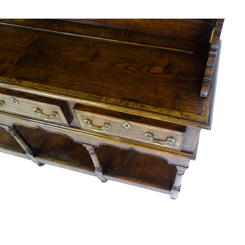 1532 - A late 20thC Bylaw & Co dresser with a graduated two tier plate rack having a moulded cornice and sh... 