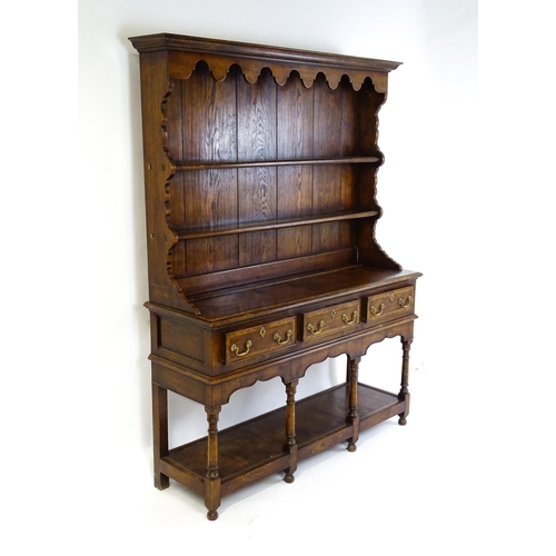 1532 - A late 20thC Bylaw & Co dresser with a graduated two tier plate rack having a moulded cornice and sh... 