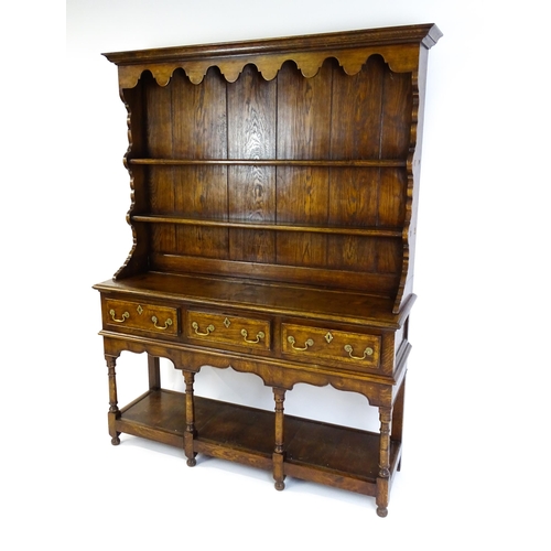 1532 - A late 20thC Bylaw & Co dresser with a graduated two tier plate rack having a moulded cornice and sh... 