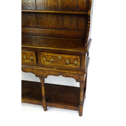 1532 - A late 20thC Bylaw & Co dresser with a graduated two tier plate rack having a moulded cornice and sh... 