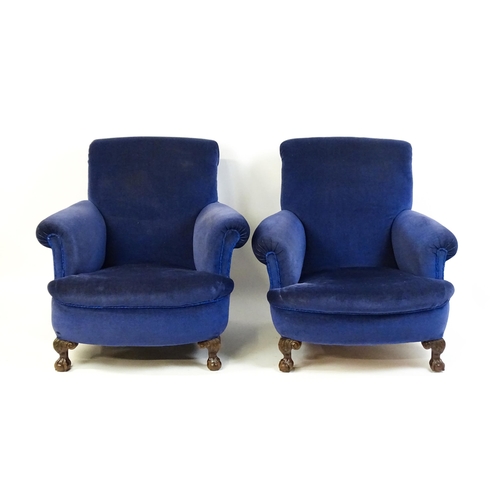 1537 - A pair of late 19thC Howard & Sons style his and hers armchairs / easy chairs with scrolled arms, sp... 
