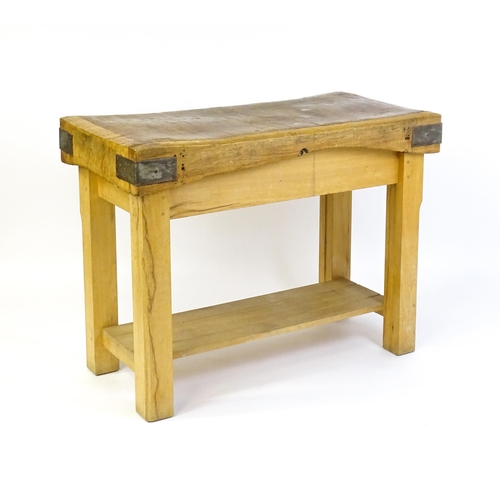 1540 - An early 20thC butchers block on a later stand, the block having corner brackets and raised on a peg... 