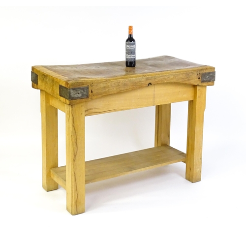 1540 - An early 20thC butchers block on a later stand, the block having corner brackets and raised on a peg... 