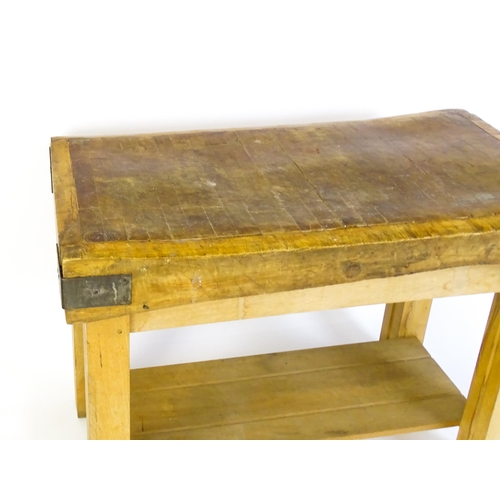 1540 - An early 20thC butchers block on a later stand, the block having corner brackets and raised on a peg... 