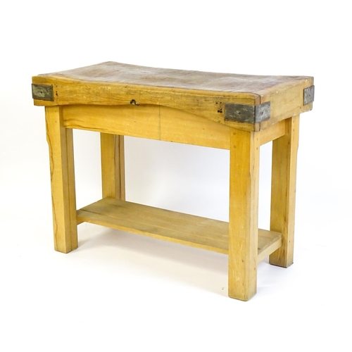 1540 - An early 20thC butchers block on a later stand, the block having corner brackets and raised on a peg... 