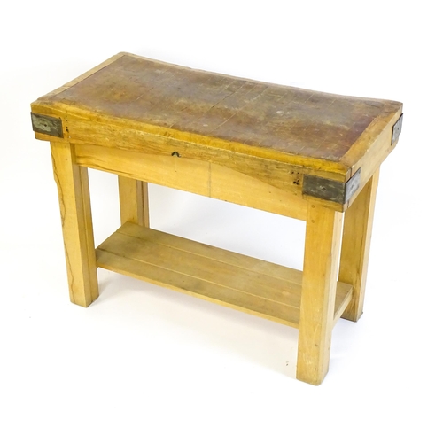 1540 - An early 20thC butchers block on a later stand, the block having corner brackets and raised on a peg... 