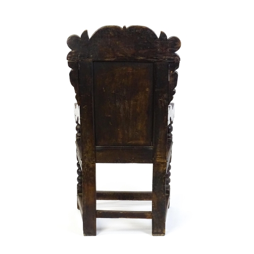1542 - A 17thC oak Wainscot chair with a scrolled, floral cresting rail above a lozenge carved backrest and... 