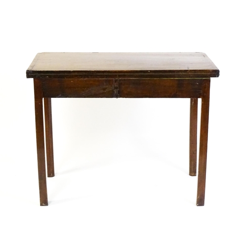 1548 - A 19thC walnut card table with a crossbanded top having re-entrant corners, the top hinging open to ... 