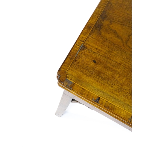 1548 - A 19thC walnut card table with a crossbanded top having re-entrant corners, the top hinging open to ... 