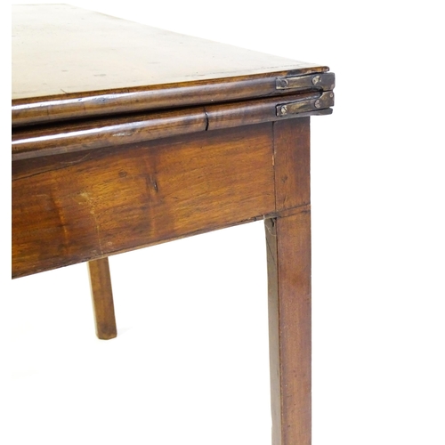 1548 - A 19thC walnut card table with a crossbanded top having re-entrant corners, the top hinging open to ... 