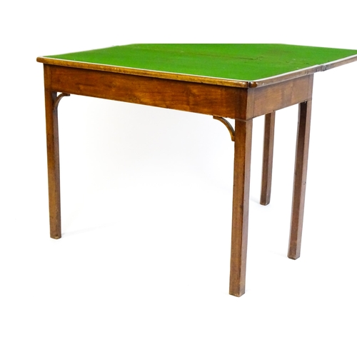 1548 - A 19thC walnut card table with a crossbanded top having re-entrant corners, the top hinging open to ... 