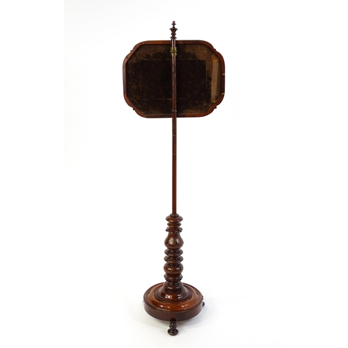 1550 - A mid 19thC mahogany pole screen, with a glazed adjustable screen having a needlework centre and re-... 