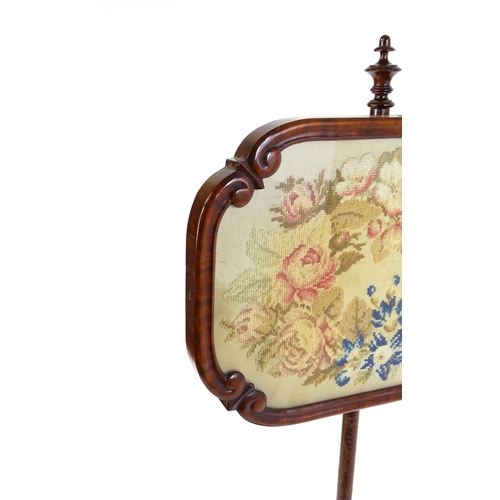 1550 - A mid 19thC mahogany pole screen, with a glazed adjustable screen having a needlework centre and re-... 