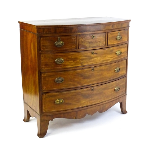 1551 - A mid 19thC mahogany chest of drawers with a bow fronted top above three short over three long drawe... 