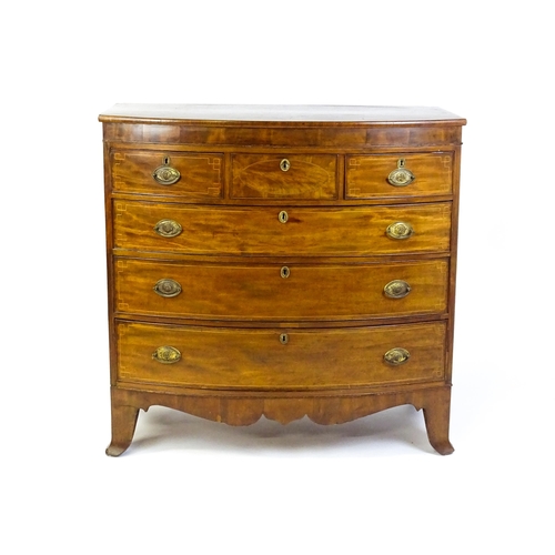 1551 - A mid 19thC mahogany chest of drawers with a bow fronted top above three short over three long drawe... 