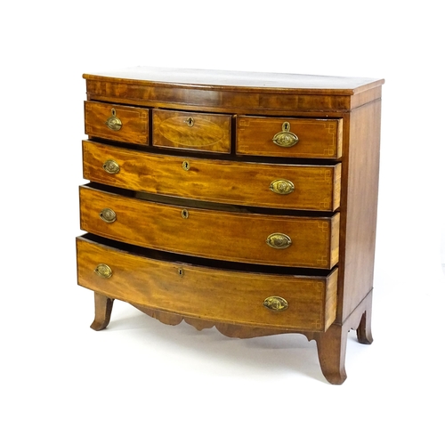 1551 - A mid 19thC mahogany chest of drawers with a bow fronted top above three short over three long drawe... 