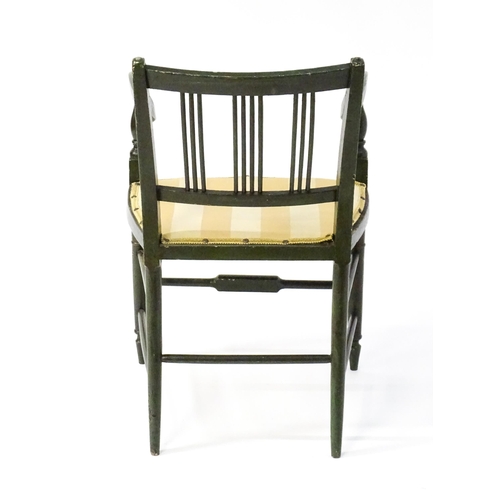 1552 - A Regency elbow chair with a green finish and neo classical painted decoration, raised on turned tap... 