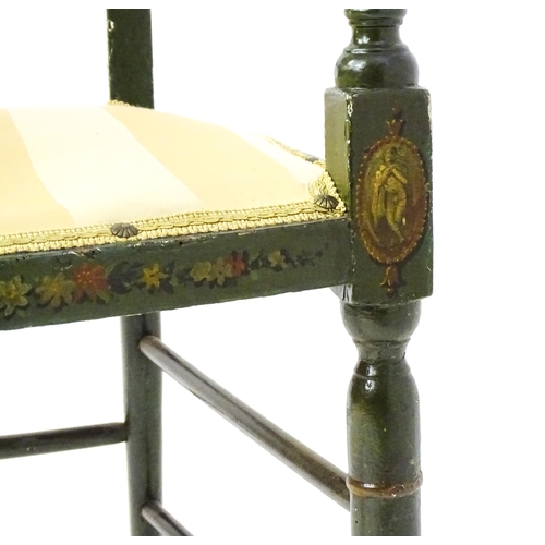 1552 - A Regency elbow chair with a green finish and neo classical painted decoration, raised on turned tap... 