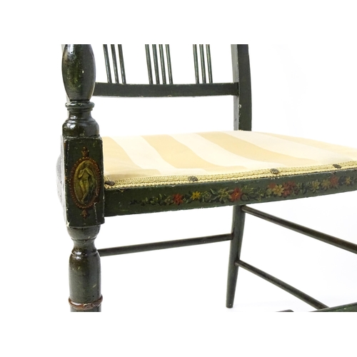 1552 - A Regency elbow chair with a green finish and neo classical painted decoration, raised on turned tap... 