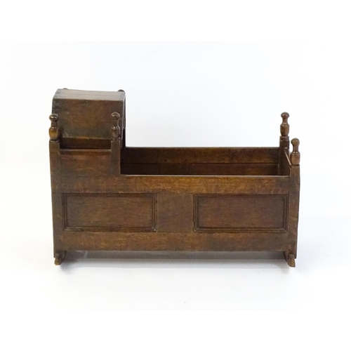 1553 - An 18thC oak crib of peg jointed construction with a hinged hood. 34