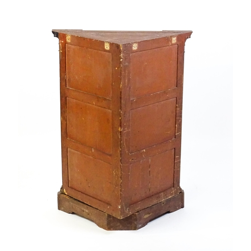 1555 - An early 19thC mahogany corner cupboard with a dentil moulded frieze and quatrefoil blink fretwork c... 