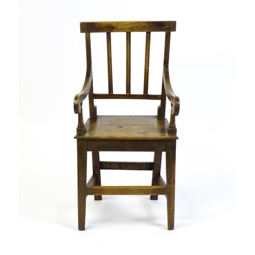 1560 - A Georgian child's chair with reeded back slats, scrolled arms and raised on tapering legs united by... 