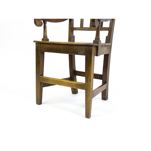 1560 - A Georgian child's chair with reeded back slats, scrolled arms and raised on tapering legs united by... 