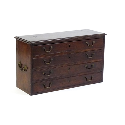 1561 - A Georgian mahogany bank of four long drawers with swan neck handles and flanked by carrying handles... 