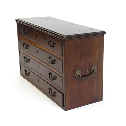 1561 - A Georgian mahogany bank of four long drawers with swan neck handles and flanked by carrying handles... 