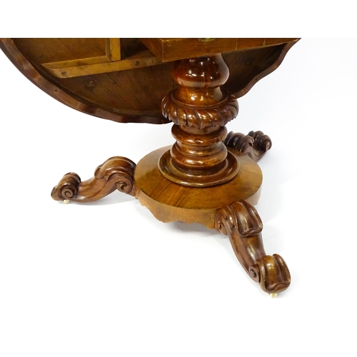 1564 - A 19thC mahogany tilt top breakfast table with a carved frieze above a turned and carved pedestal ba... 