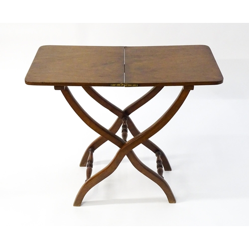 1565 - A Georgian mahogany coaching table / metamorphic table with a hinged top and folding base formed fro... 