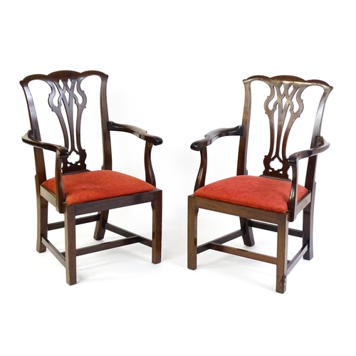 1567 - A pair of Chippendale style mahogany elbow chairs with a drop in seat raised on chamfered legs unite... 